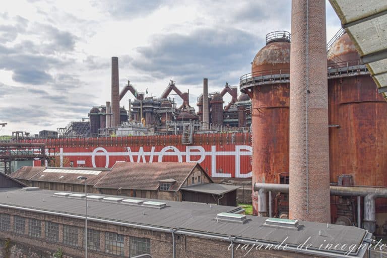 Tuberías y chimeneas deVölklingen Ironworks junto a las letras blancas Hellos World