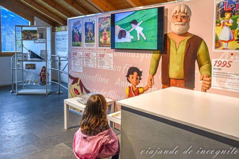 Una niña de espaldas ve la tele del museo de la casa de Heidi en Suiza donde están retransmitiendo el capítulo 1 de la serie de dibujos de 1974